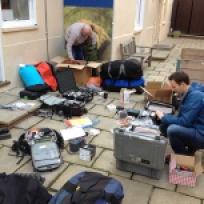 Neil, Andy, kit packing. Notice Andy hiding fishing gear in the kit!